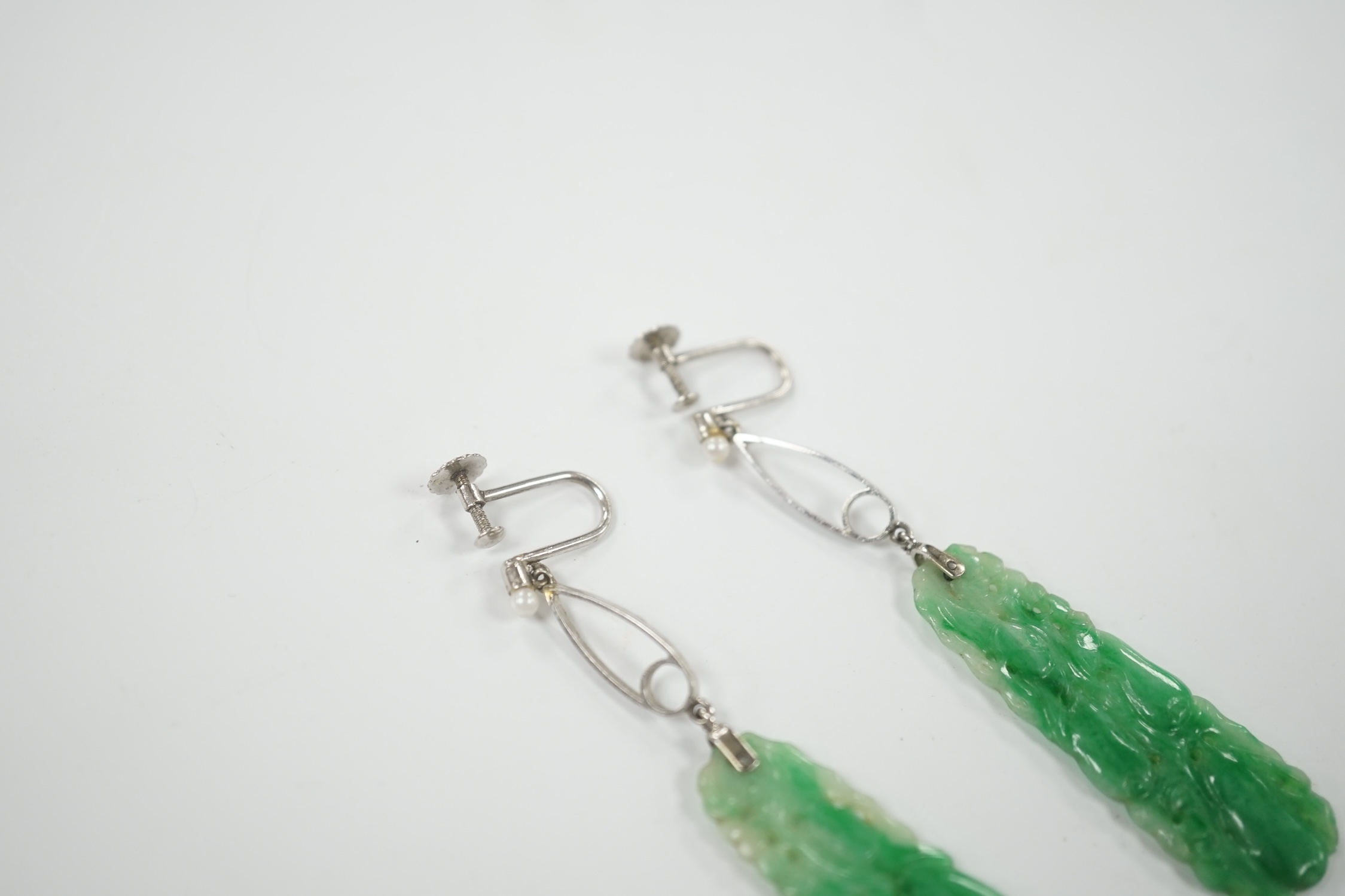 A pair of 9ct white metal, seed pearl and carved jade set drop ear clips, overall 7cm.